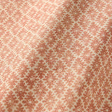 Fabric sample of a orange and neutral printed linen fabric with a geometric pattern