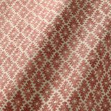 Fabric sample of a red and neutral printed linen fabric with a geometric pattern