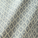 Fabric sample of a blue and neutral printed linen fabric with a geometric pattern