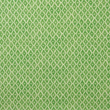 Fabric sample of a green and neutral printed linen fabric with a geometric pattern