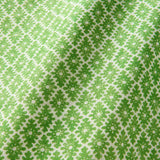 Fabric sample of a green and neutral printed linen fabric with a geometric pattern