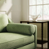 Sofa upholstered in a green and neutral printed linen fabric with a geometric pattern