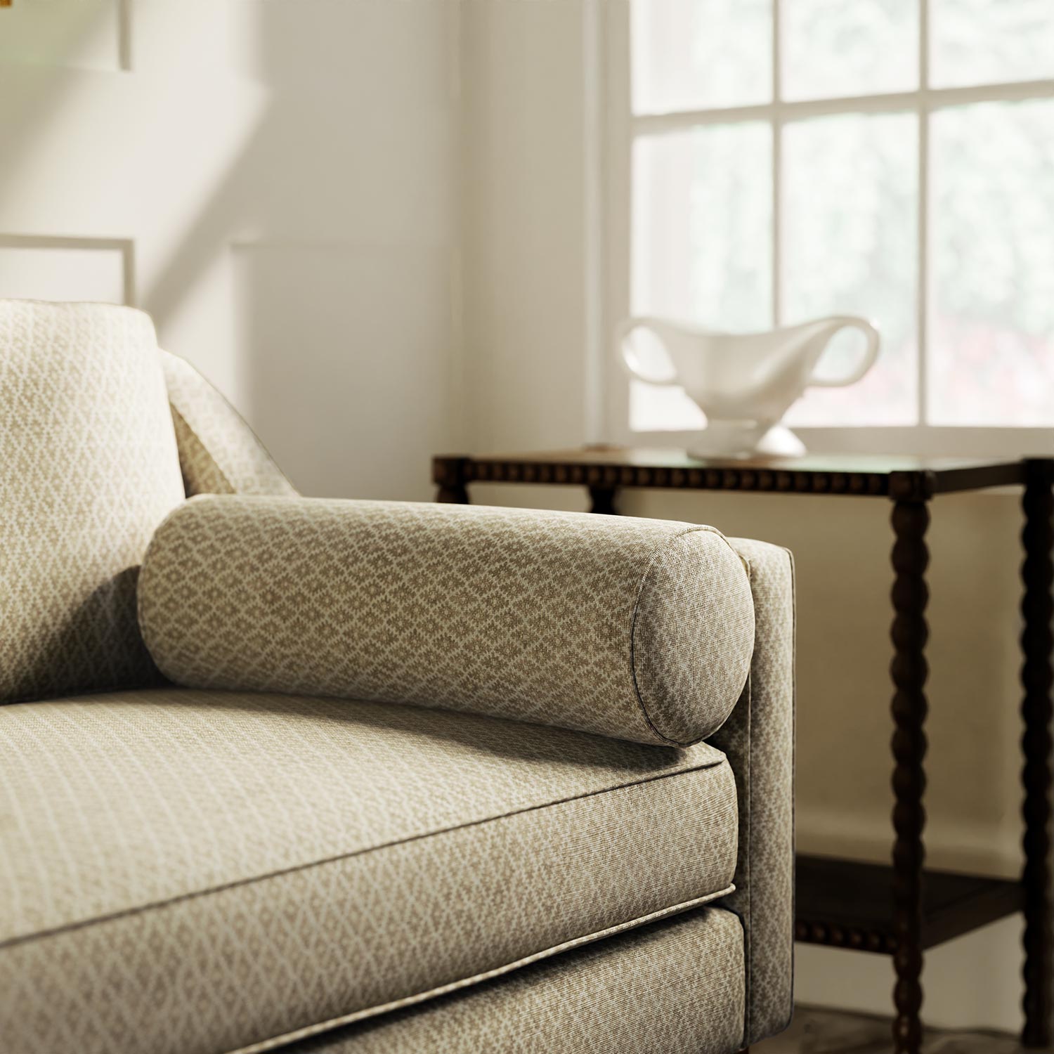 Sofa upholstered in a yellow and neutral printed linen fabric with a geometric pattern