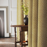 Curtains in a yellow and neutral printed linen fabric with a geometric pattern