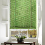 Blind in a green and neutral printed linen fabric with a geometric pattern