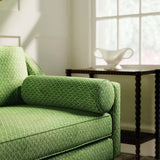 Sofa upholstered in a green and neutral printed linen fabric with a geometric pattern