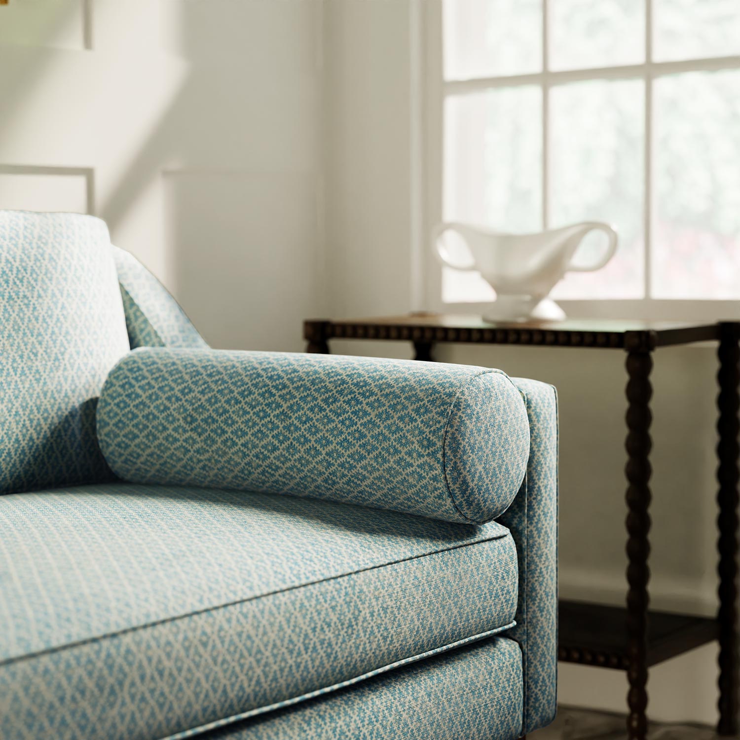 Sofa upholstered in a blue and neutral printed linen fabric with a geometric pattern