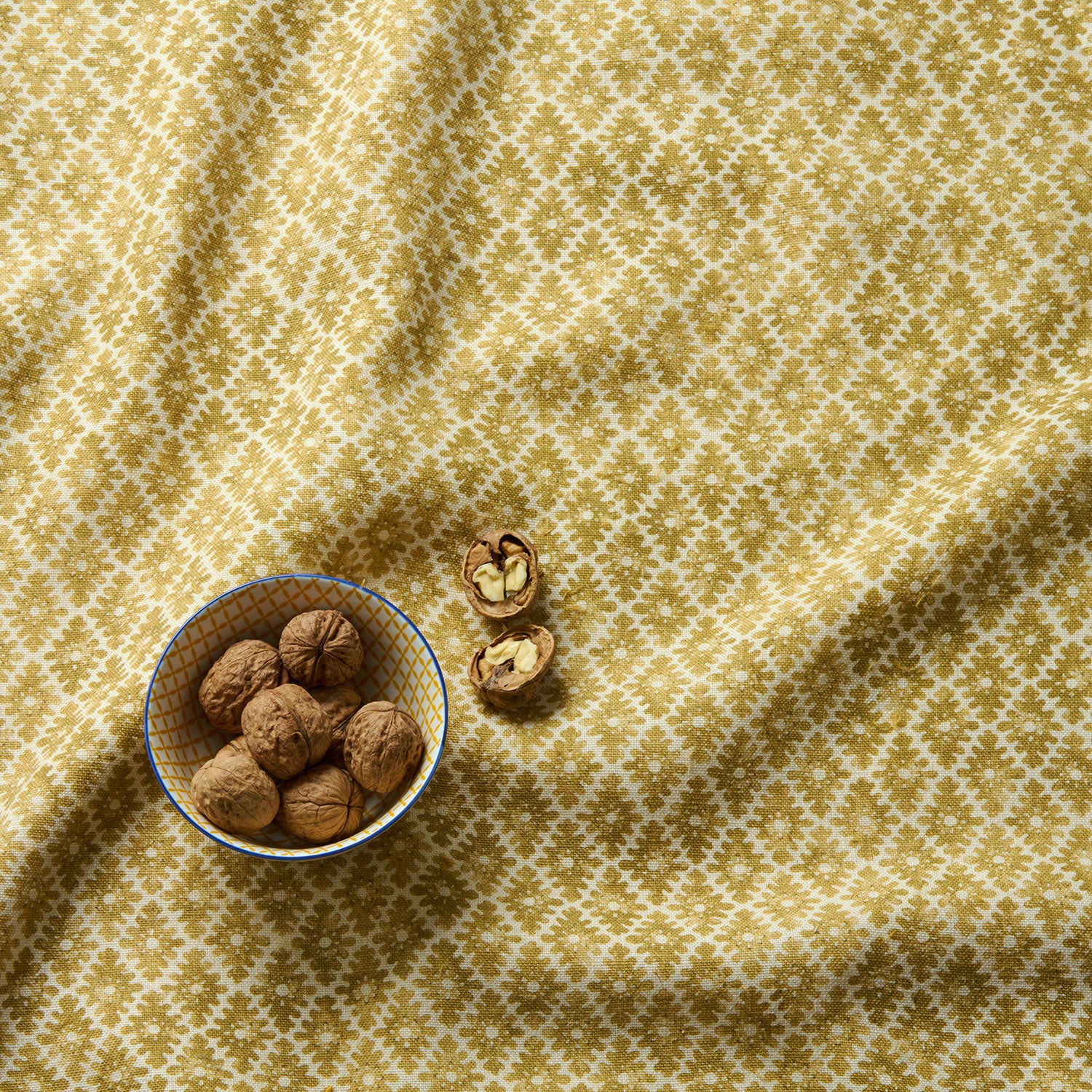 Fabric sample of a yellow and neutral printed linen fabric with a geometric pattern