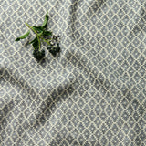 Fabric sample of a blue and neutral printed linen fabric with a geometric pattern