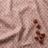 Fabric sample of red and neutral printed linen fabric with a geometric pattern