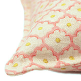 A pink, yellow and cream linen cushion with a trellis pattern.