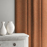 Orange curtain made from a herringbone pure wool woven fabric.