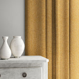 Yellow curtain made from a herringbone pure wool woven fabric.