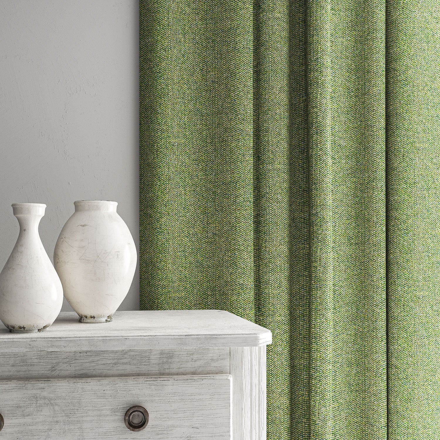 Green curtain made from a herringbone pure wool woven fabric.