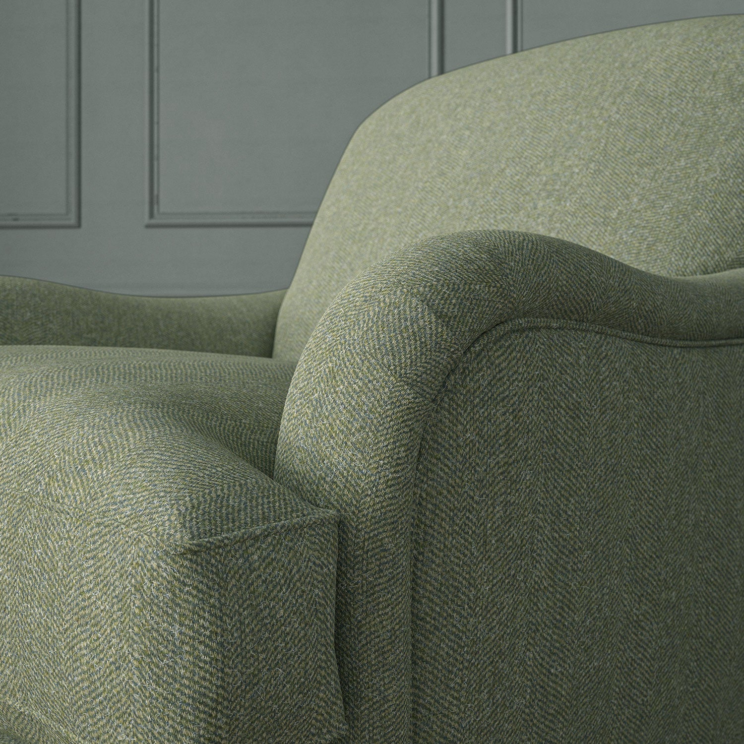 Green chair upholstered in a herringbone pure wool woven fabric.