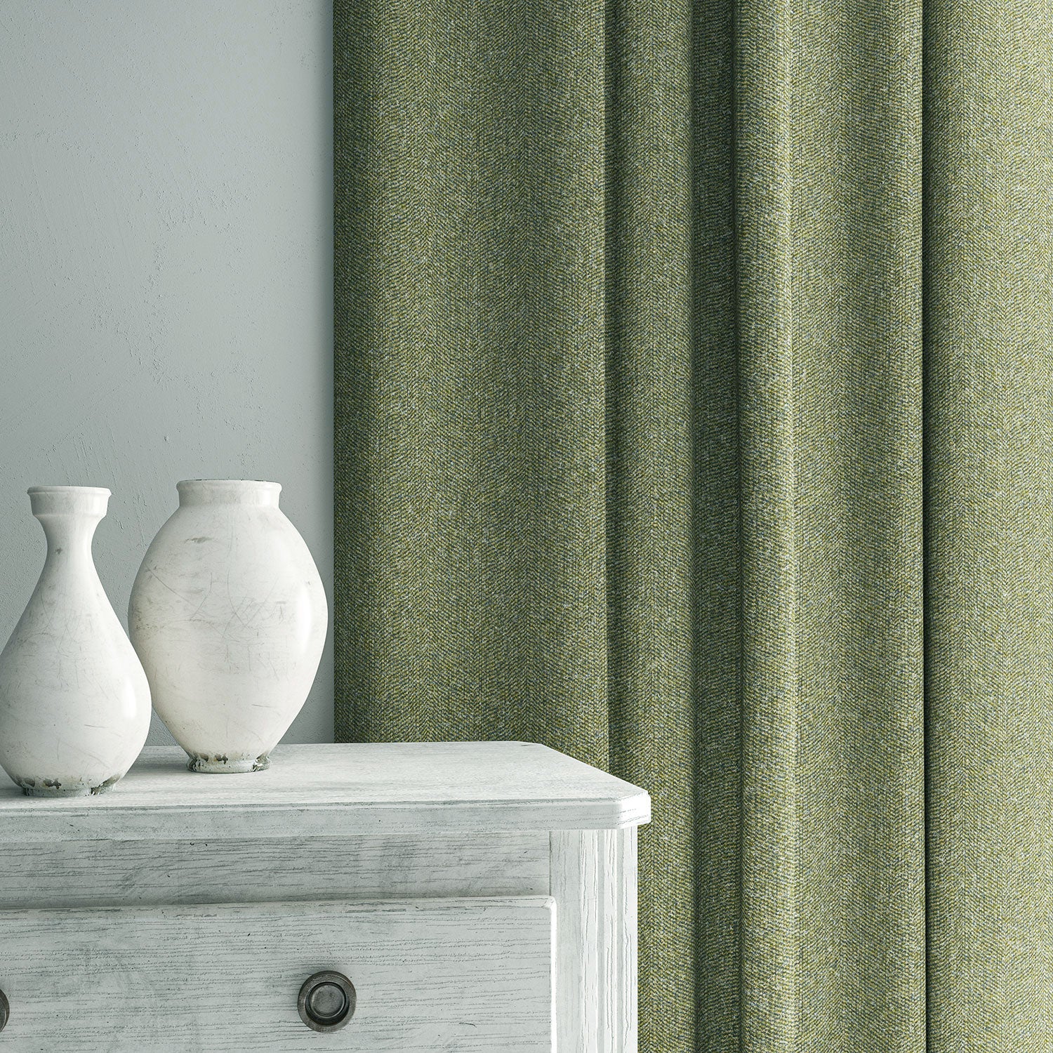 Green curtain made from a herringbone pure wool woven fabric.