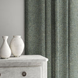 Blue curtain made from a plain pure wool woven fabric.