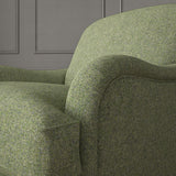 Green chair upholstered in a plain pure wool woven fabric.