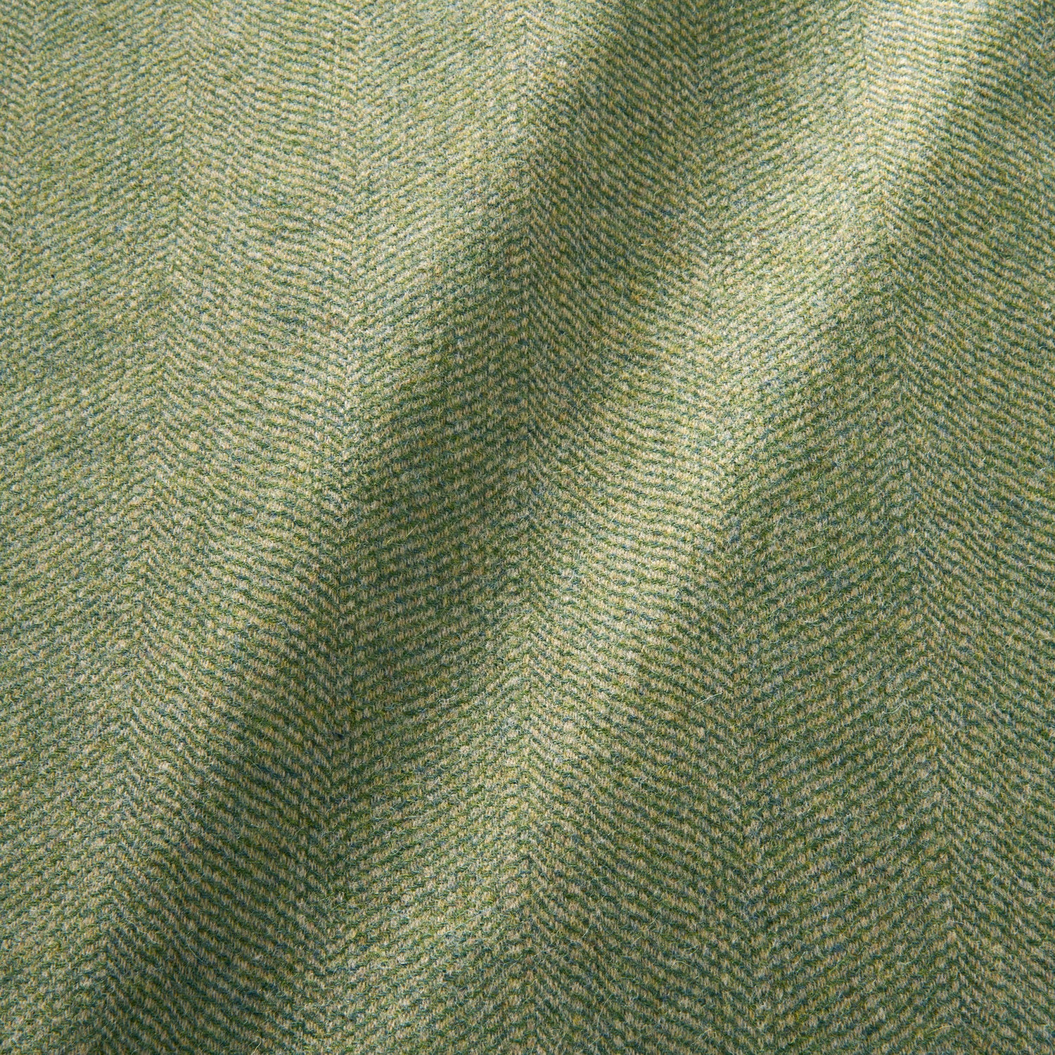 Sample of a classic herringbone woven fabric in green.