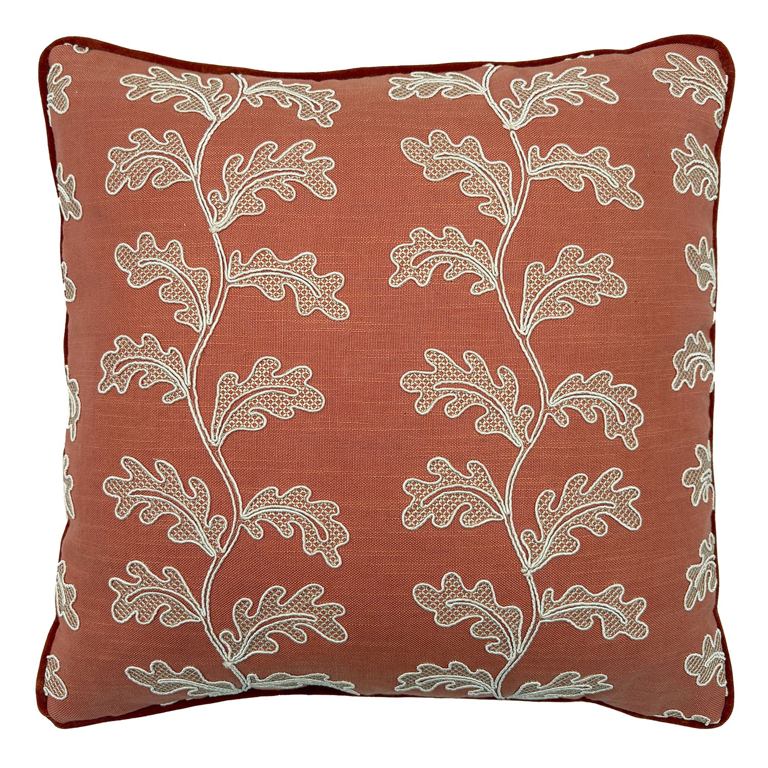 Decorative coral cushion with a off-white leaf pattern.