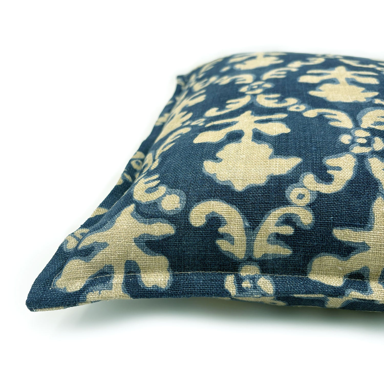 Decorative pillow with blue and beige floral pattern on a off-white background