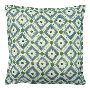 Decorative cushion with a geometric floral pattern in blue and green.