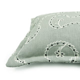 Decorative cushion with a free-flowing floral pattern on a light blue background.