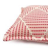Pink cushion with geometric red pattern.