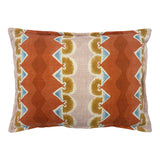 Decorative cushion with geometric pattern in rust, blue and ochre.
