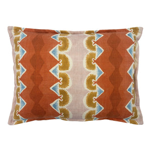 Decorative cushion with geometric pattern in rust, blue and ochre.