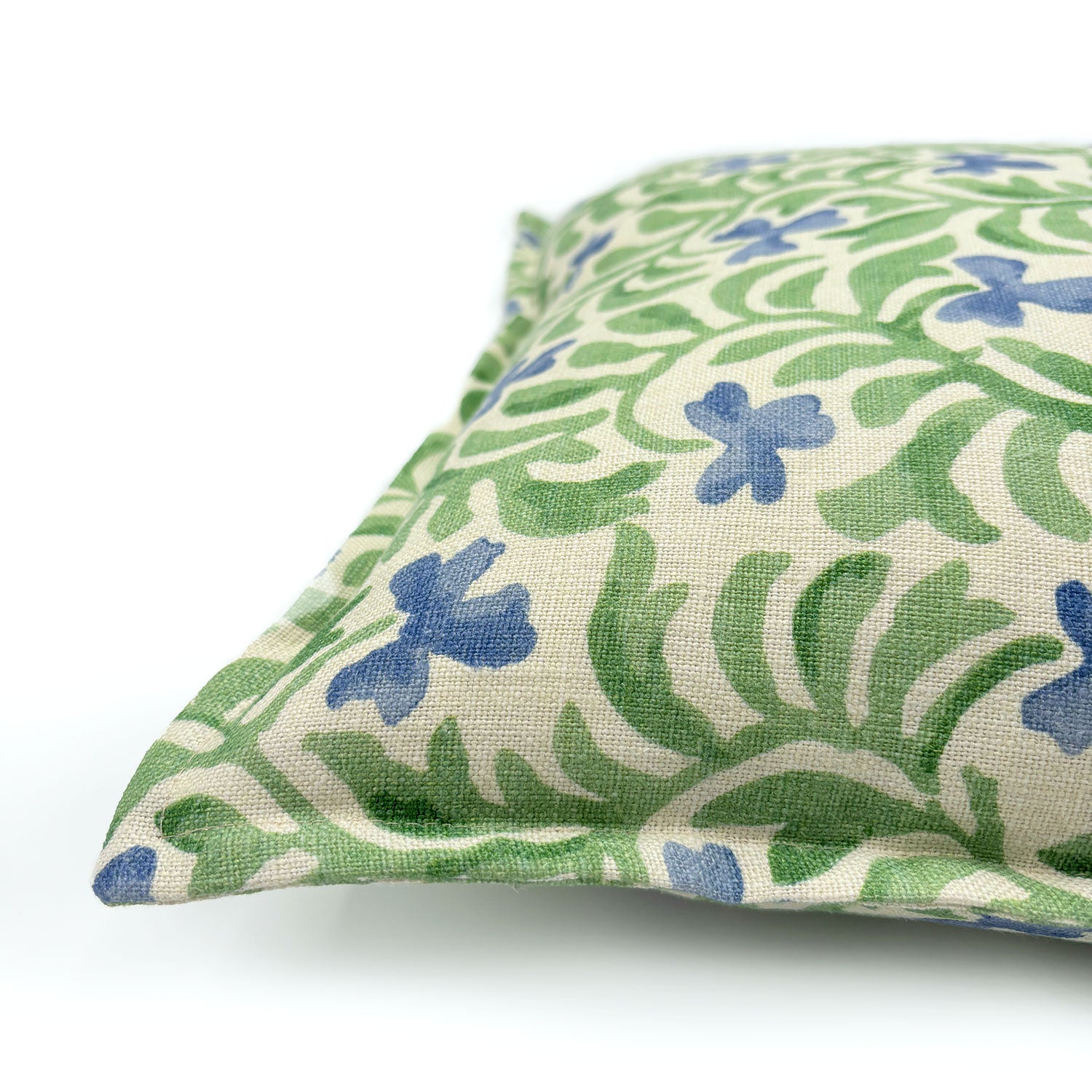 Decorative cushion with a green and blue floral pattern.