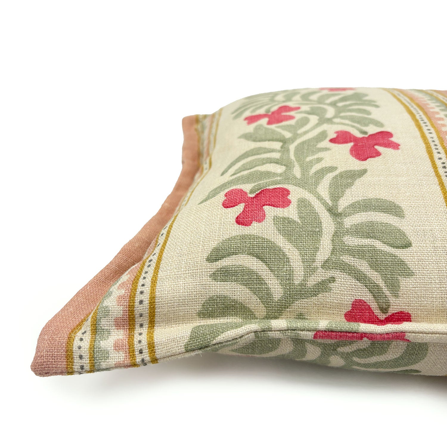 Decorative cushion with floral patterns and stripes on a off-white background.