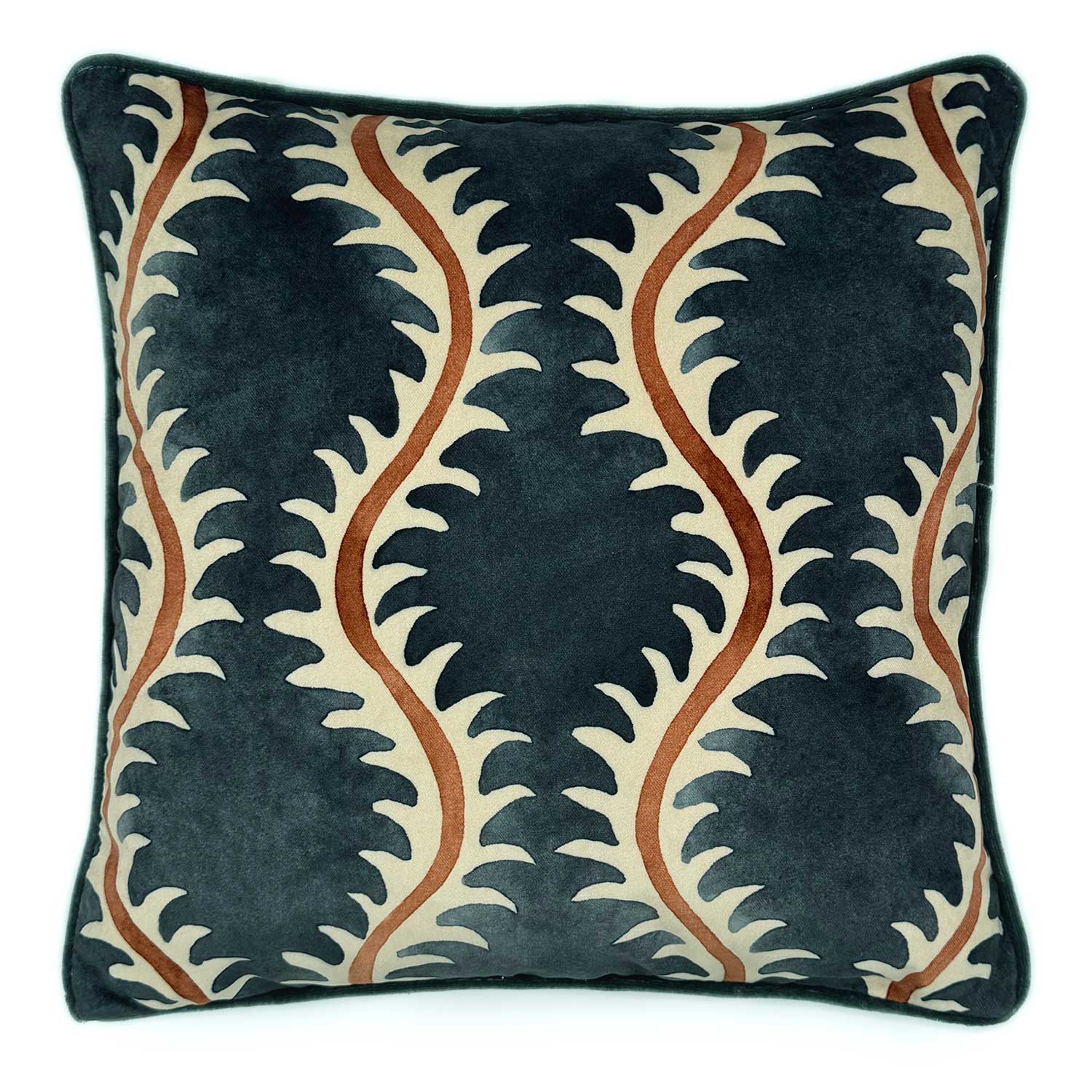 A orange, blue and off white velvet cushion with a all-over repeat pattern and velvet piping.