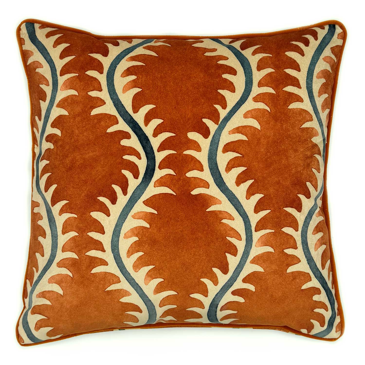 A orange, blue and off white velvet cushion with a all-over repeat pattern and velvet piping.