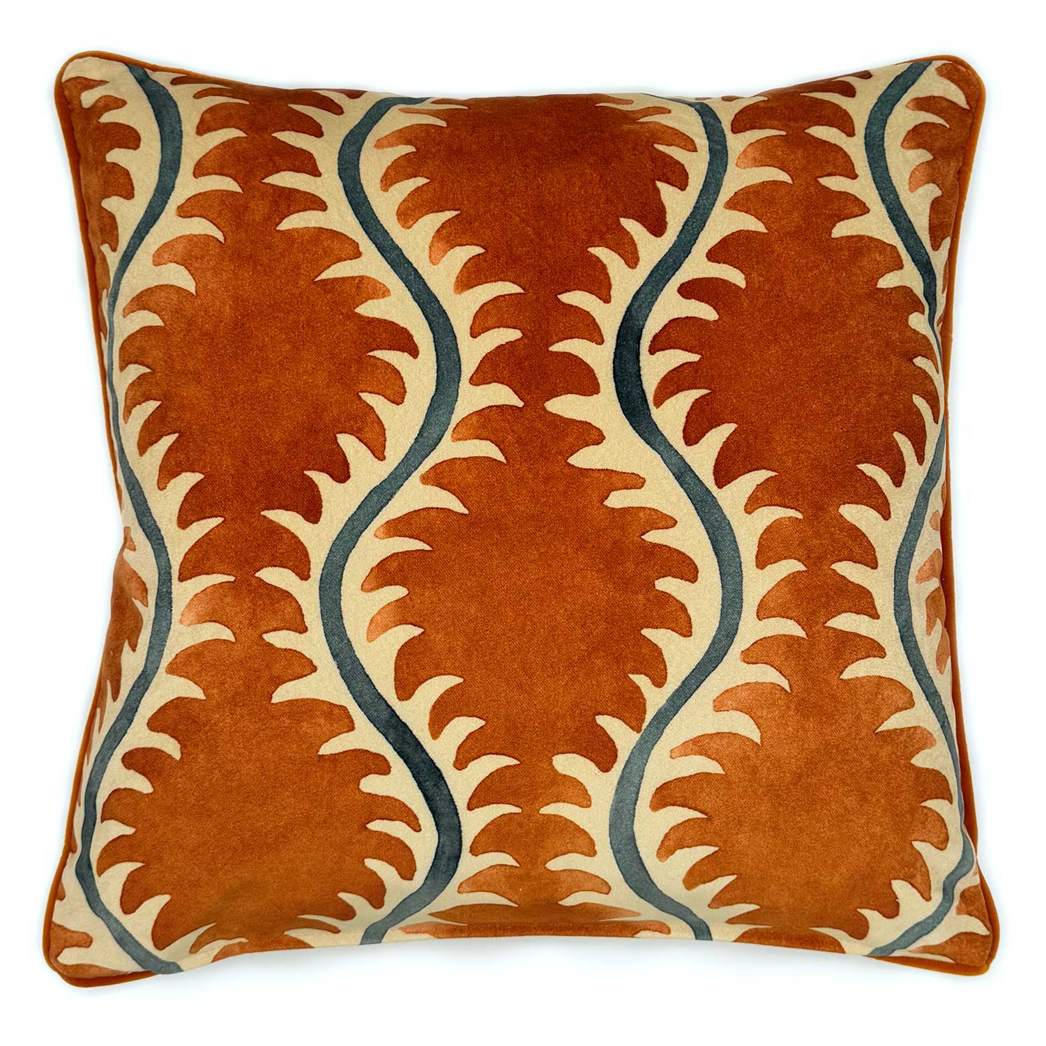 A orange, blue and off white velvet cushion with a all-over repeat pattern and velvet piping.