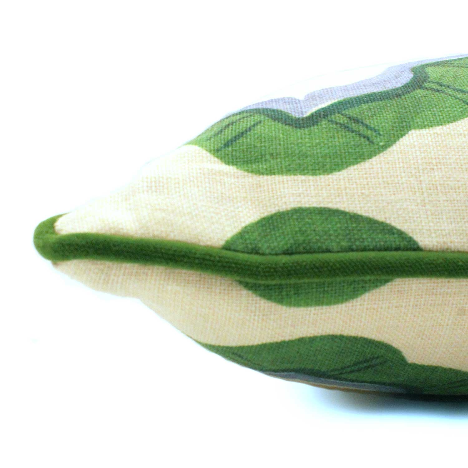 A green, blue and off white linen cushion featuring a mirrored ribbon pattern with a velvet piping.