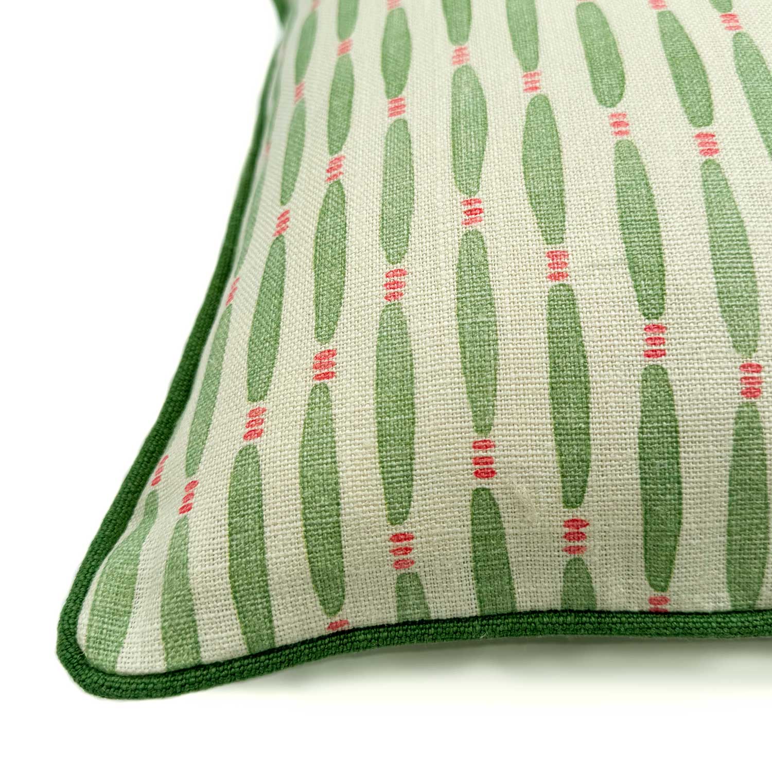 A green, pink and off white linen cushion featuring a beautiful small-scale pattern with a velvet piping.