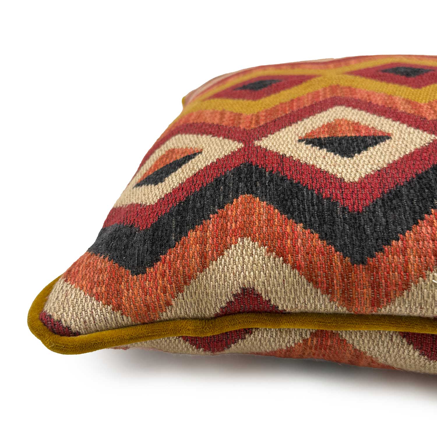 Close-up side view of Linwood cushion in Amala Red, showing the intricate weave and contrast velvet piping detail.