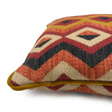Close-up side view of Linwood cushion in Amala Red, showing the intricate weave and contrast velvet piping detail.