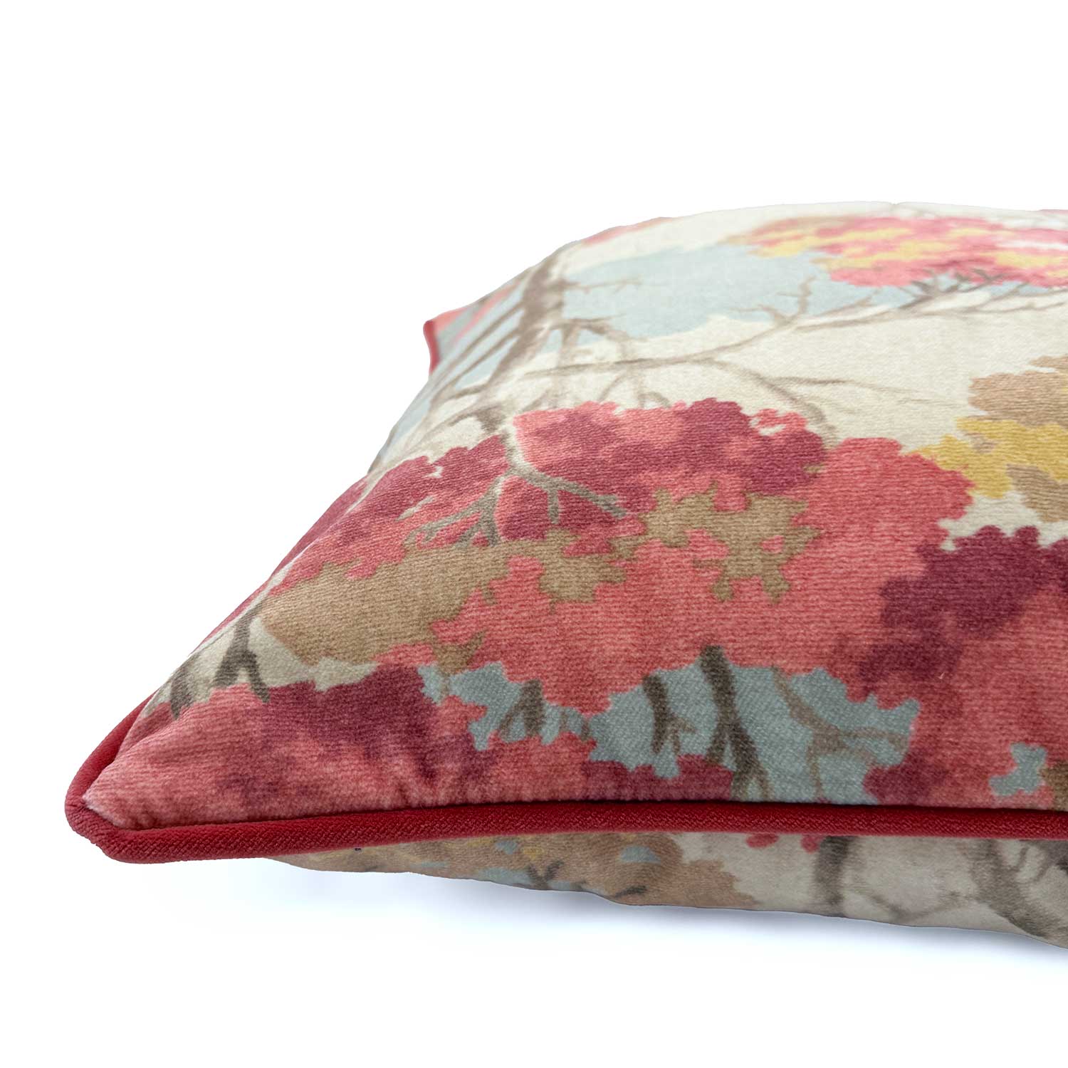 Close-up side view of Linwood cushion in Arboreal Cloud, showing the fabric texture and contrast red piping detail.