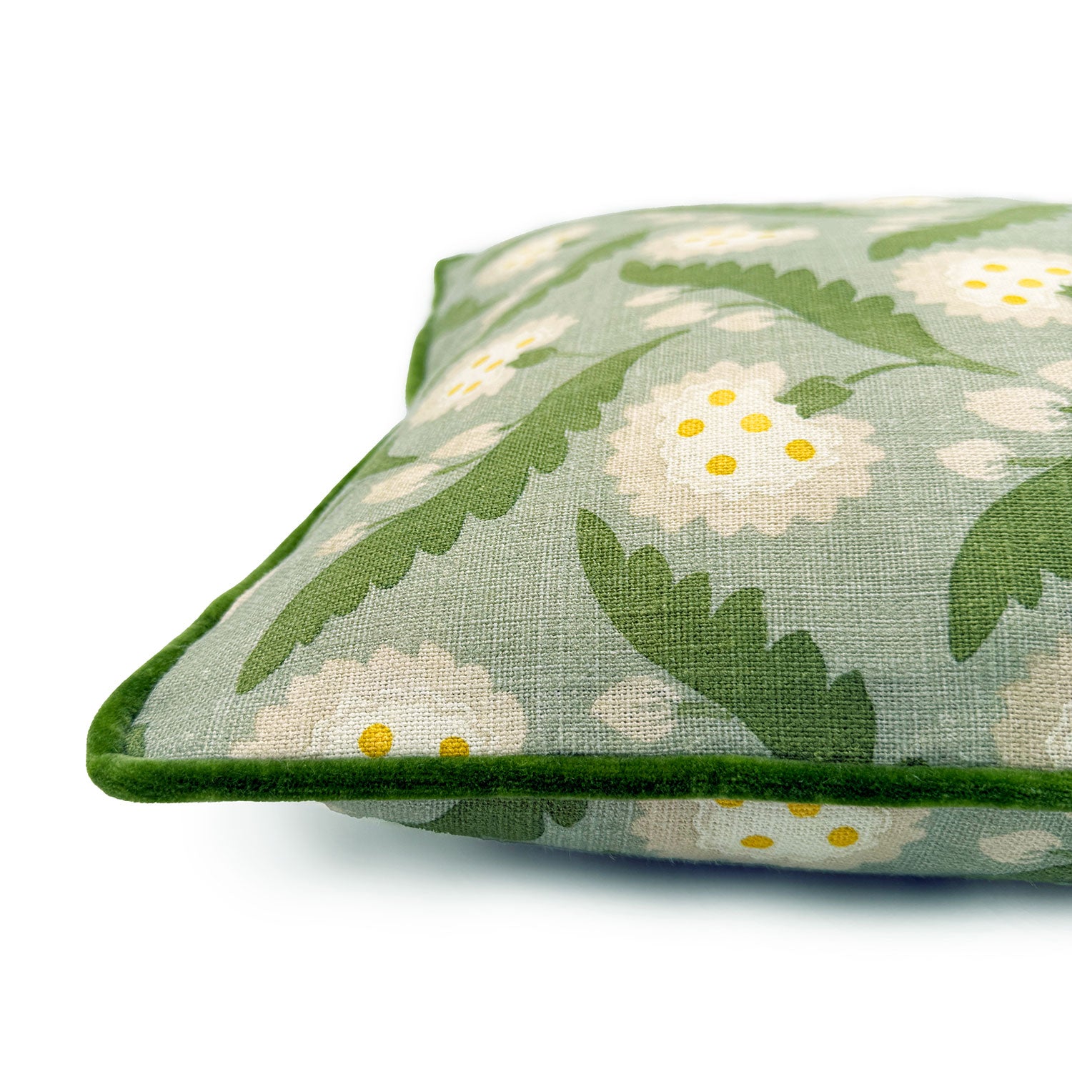 Close-up side view of Linwood cushion in Polly, Moss showing fabric texture and piping in a luxurious green velvet.