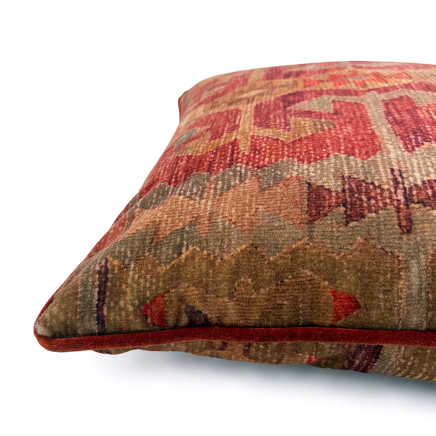 Close-up side view of Linwood cushion in Samimi, Earth, showing the fabric texture and red velvet piping detail.