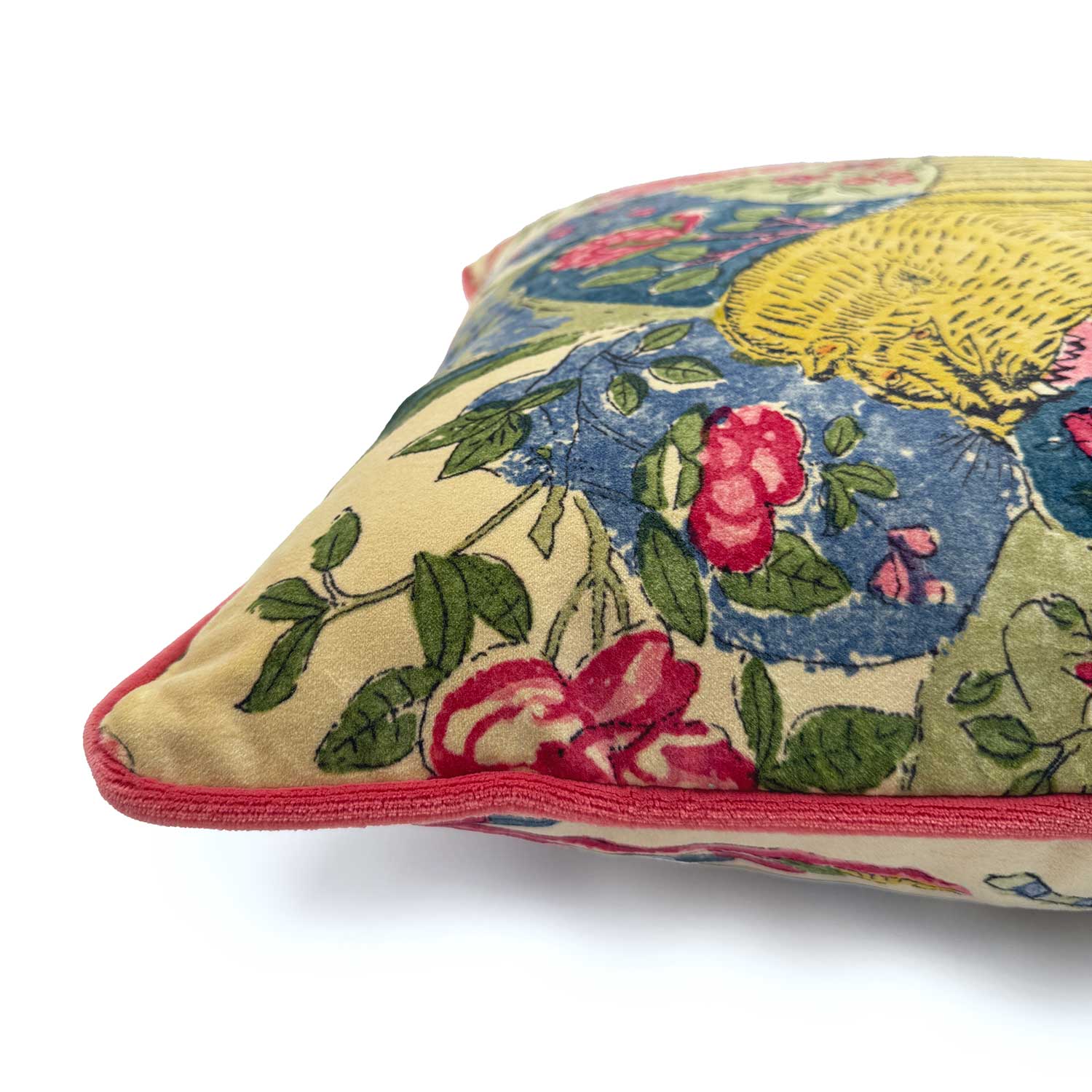 Close-up side view of Linwood cushion in Wild Multi, showing the contrast pink piping detail.
