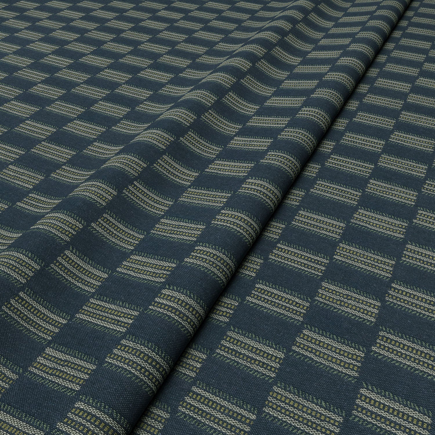 Strata fabric in Denim, styled in a wave to show horizontal structure and depth.
