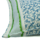 A green, blue and cream linen cushion with a stylised coral pattern.