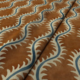 A printed velvet fabric sample in brown and blue featuring a stylized fern pattern.