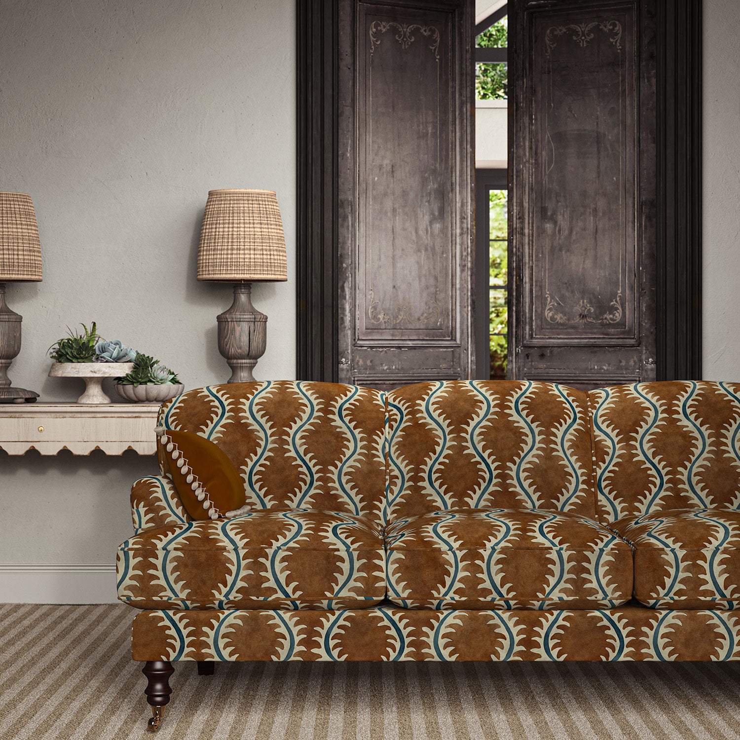 Sofa upholstered in a printed velvet fabric in brown and blue featuring a stylized fern pattern.