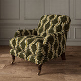 Armchair upholstered in a printed velvet fabric in brown and green featuring a stylized fern pattern.