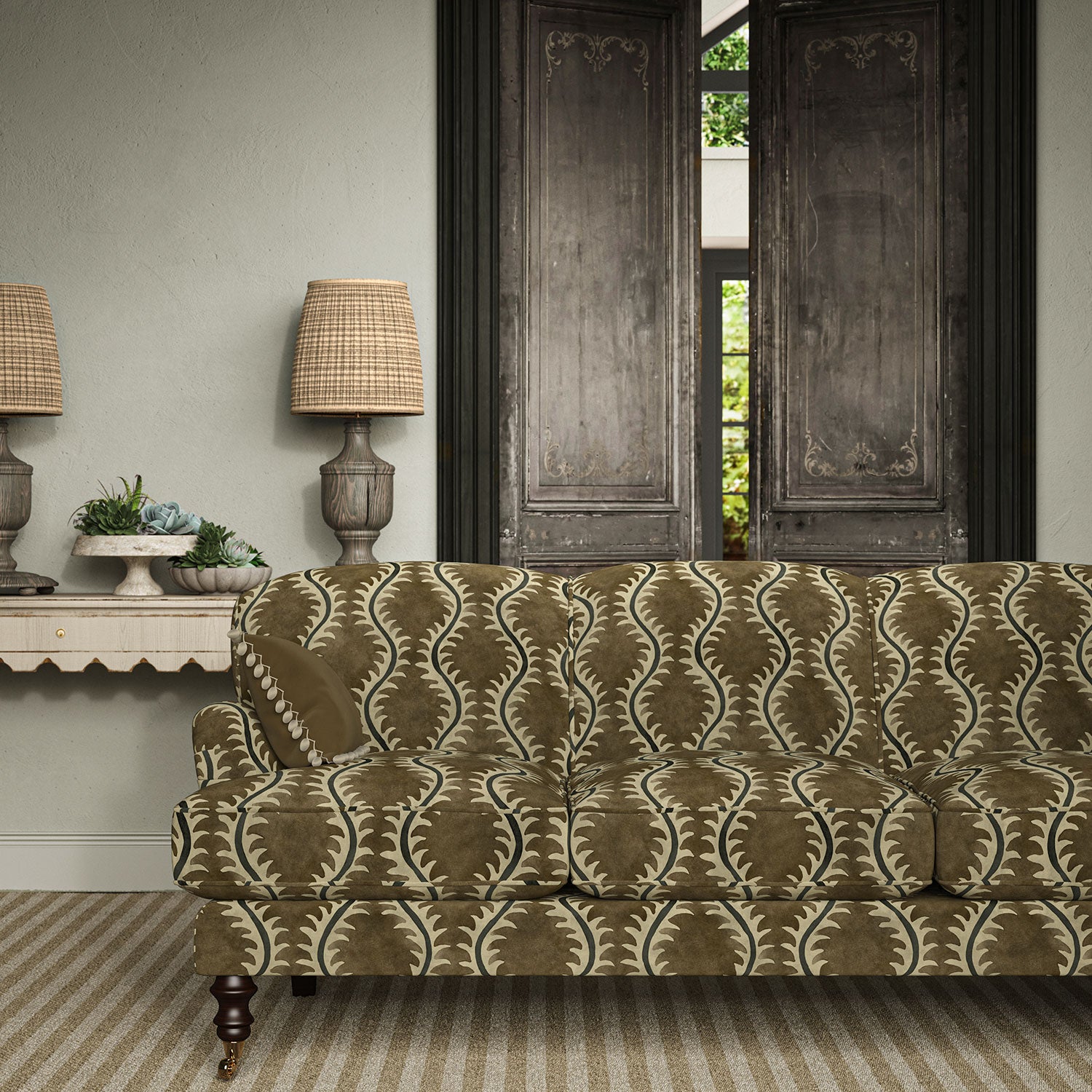 Sofa upholstered in a printed velvet fabric in brown and grey featuring a stylized fern pattern.