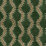 A printed velvet fabric sample in green and orange featuring a stylized fern pattern.